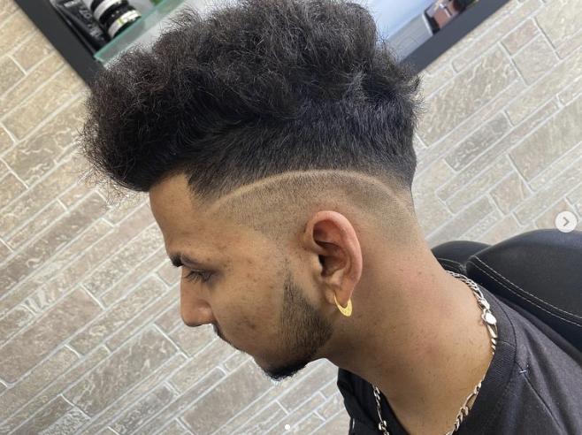 Fresh fade haircut with a clean shaved design