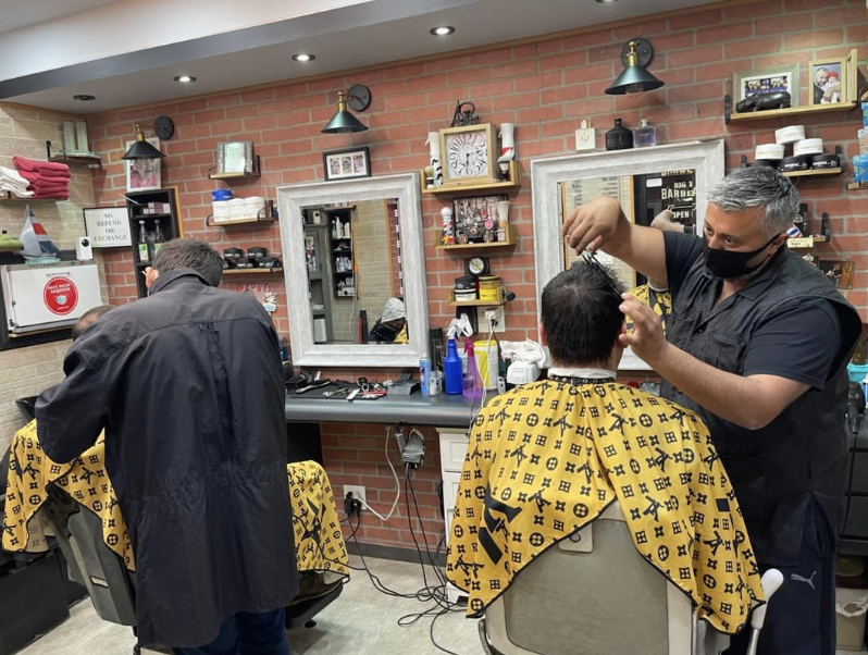 A barber giving a careful haircut